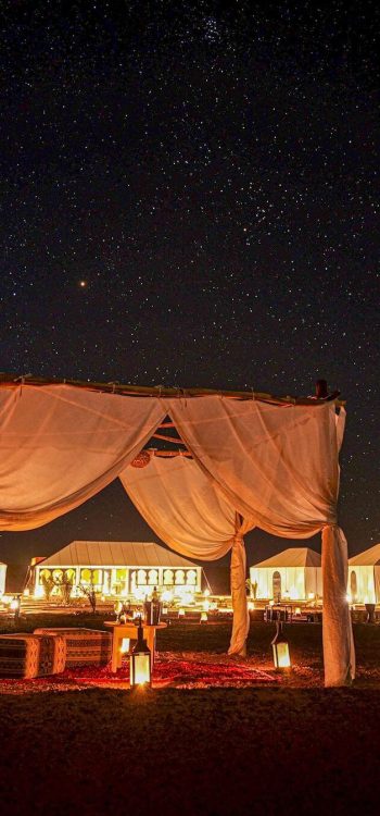 Camel caravan crossing the golden Sahara dunes during a 7 Days tour from Tangier to Marrakech Morocco tour